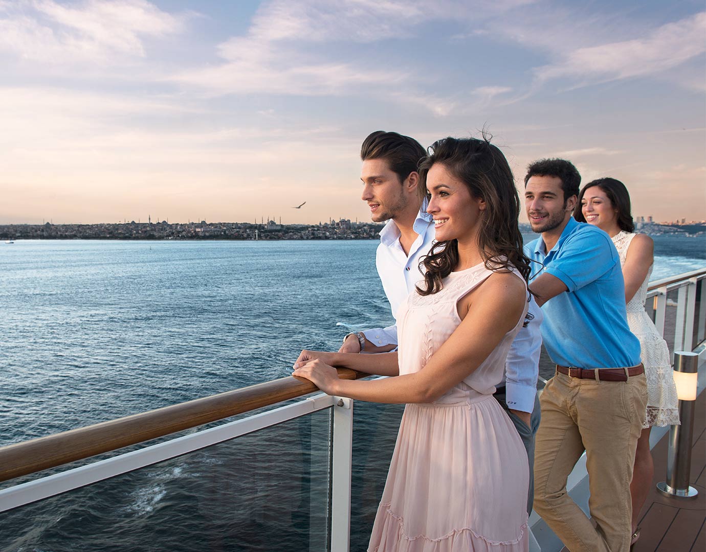 Guests enjoying ocean views from a cruise ship deck at sunset | MSC Cruises Guests enjoying ocean views from a cruise ship deck at sunset | MSC Cruises