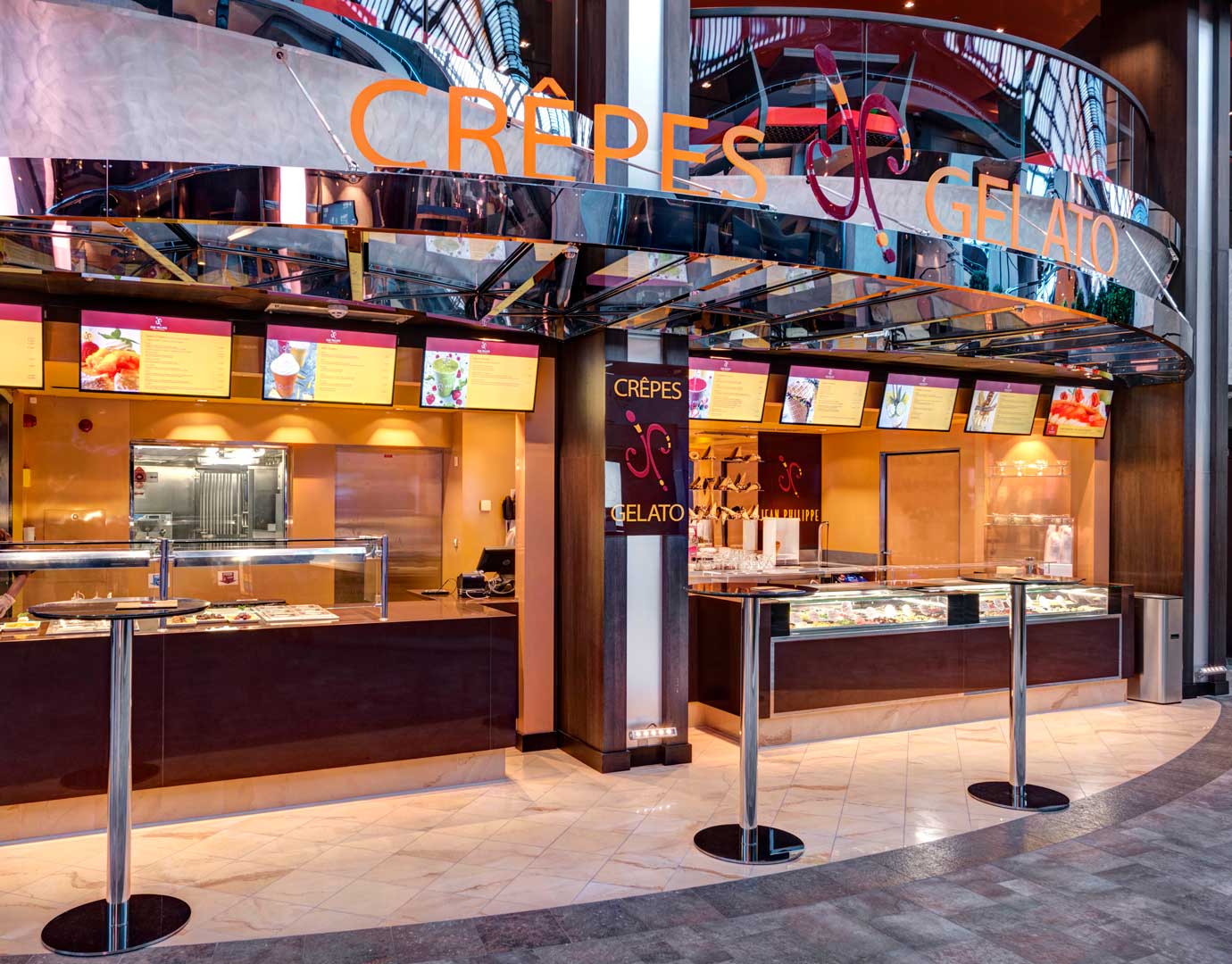 Crepes and gelato stand onboard with colorful menus and dessert displays | MSC Cruises Crepes and gelato stand onboard with colorful menus and dessert displays | MSC Cruises