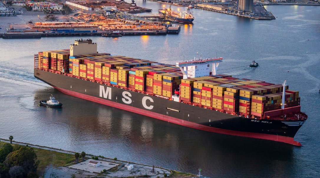 A large MSC container ship navigating through the harbor | MSC Cruises A large MSC container ship navigating through the harbor | MSC Cruises