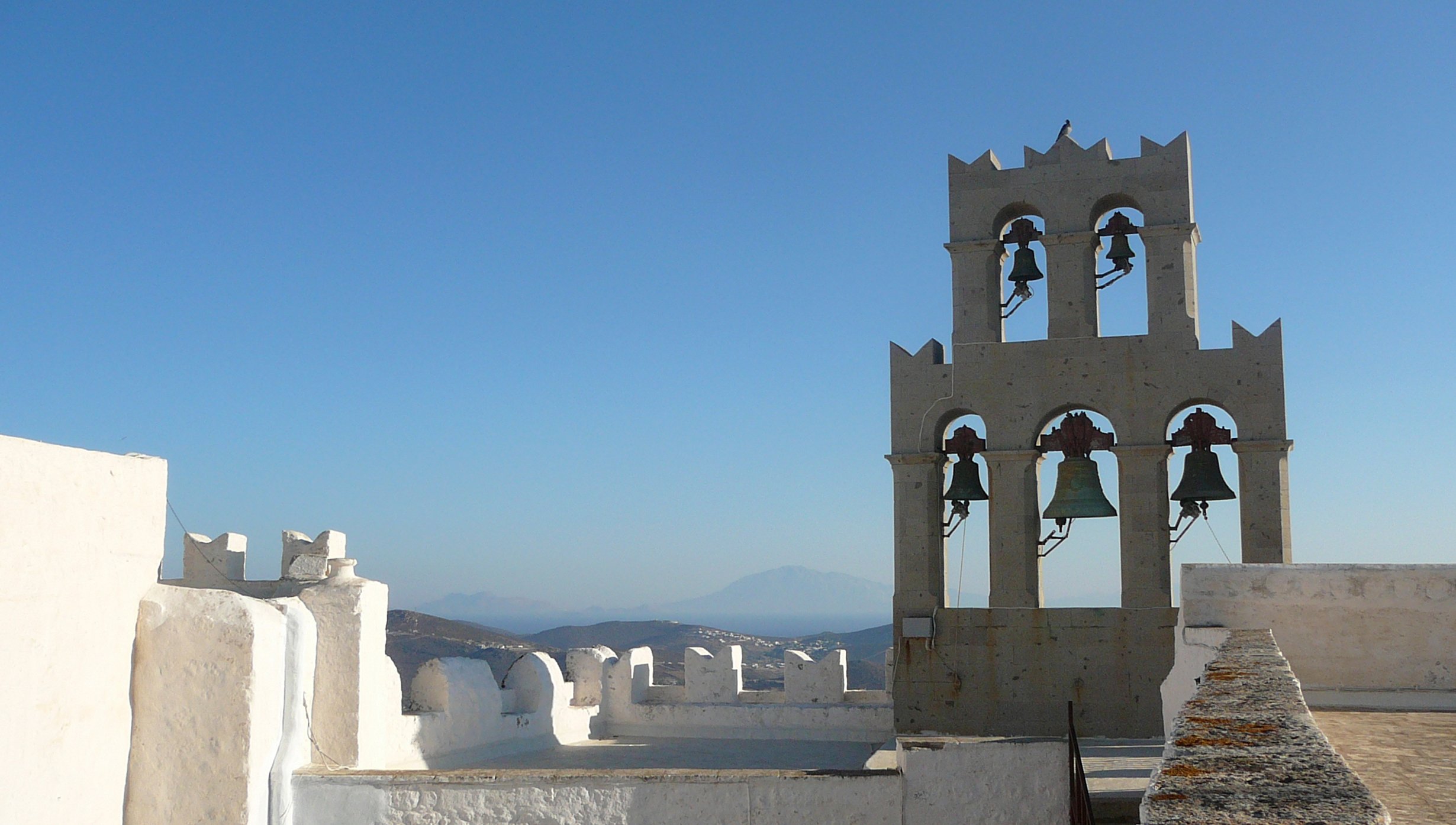 A historic Greek monastery bell tower overlooking the Aegean Sea | MSC Cruises A historic Greek monastery bell tower overlooking the Aegean Sea | MSC Cruises