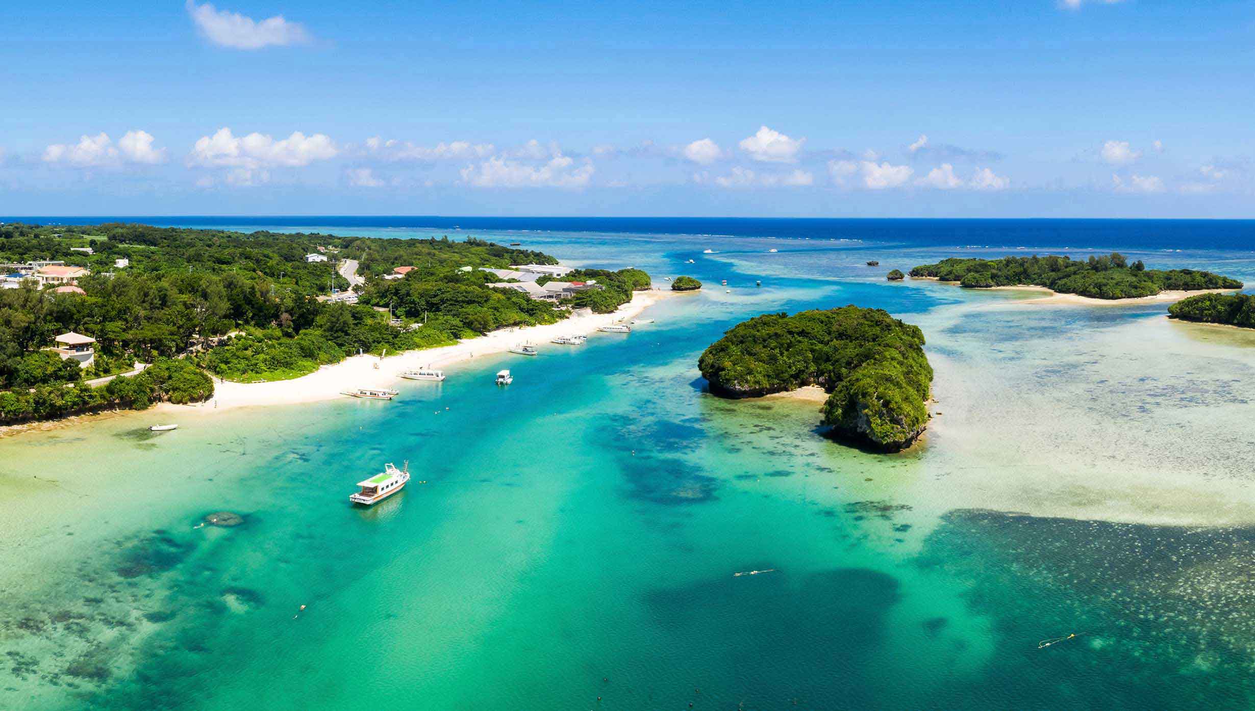 Tropical islands with turquoise waters and boats near white sandy beaches | MSC Cruises Tropical islands with turquoise waters and boats near white sandy beaches | MSC Cruises