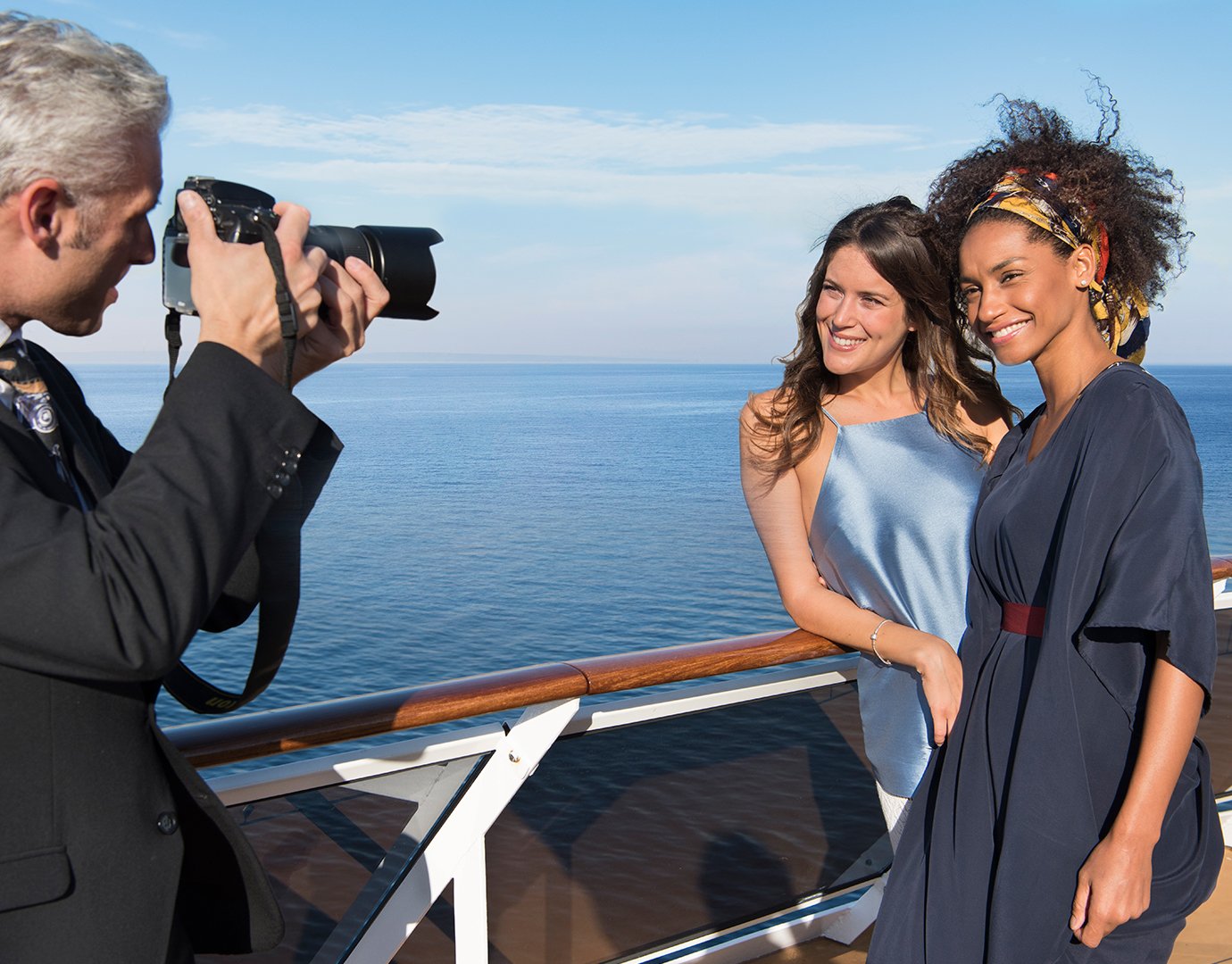 A photographer capturing two women on a cruise ship deck with a sea view | MSC Cruises A photographer capturing two women on a cruise ship deck with a sea view | MSC Cruises
