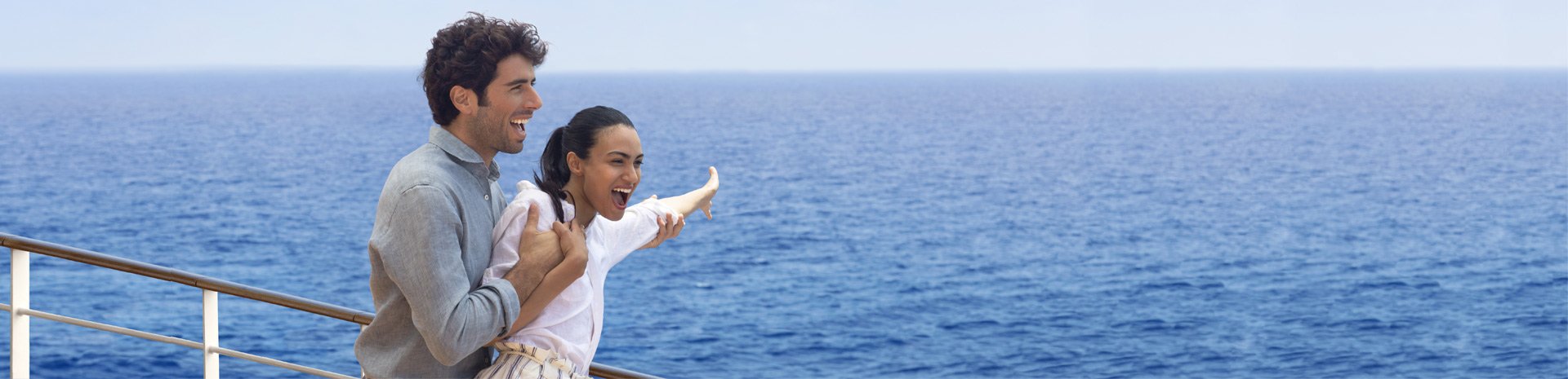 A man and child enjoying ocean views from a cruise ship deck | MSC Cruises A man and child enjoying ocean views from a cruise ship deck | MSC Cruises