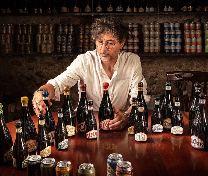 A variety of craft beer bottles displayed on a table in a cozy setting | MSC Cruises A variety of craft beer bottles displayed on a table in a cozy setting | MSC Cruises